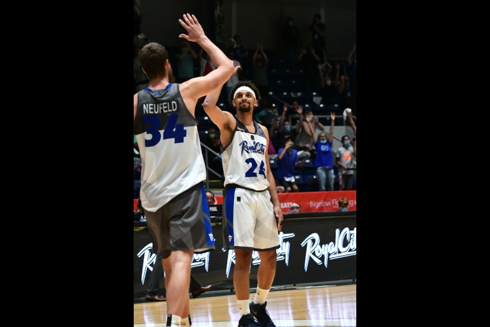 Michael Bryson (24) of the Guelph Nighthawks gets set to exchange high fives with Matt Neufeld after sinking three consecutive free throws for an 89-85 victory in CEBL league play in front of appreciative fans Friday night at the Sleeman Centre.