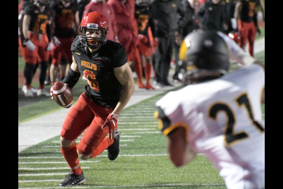 Clark Barnes (left) of the Guelph Gryphons starts to head to the Waterloo Warriors endzone for a touchdown on an 11-yard catch-and-run play Saturday night at Alumni Stadium. Barnes had two touchdowns in a 27-10 win by the Gryphons.