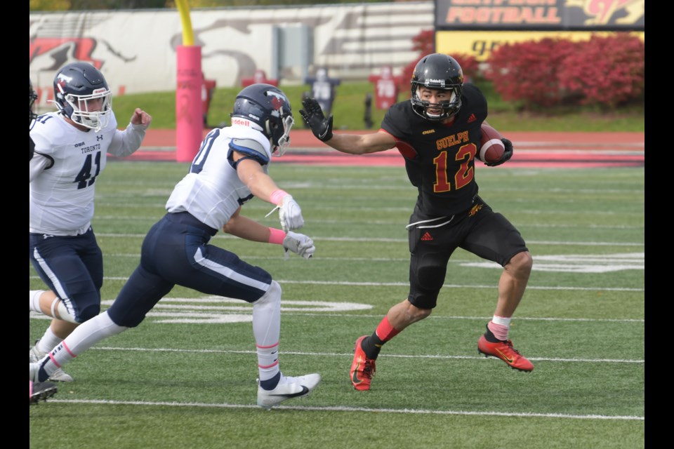 Kiondre Smith of the Guelph Gryphons tries to keep a Toronto Varsity Blues defender at bay during a punt return in OUA football play Saturday at Alumni Stadium. The Gryphons turned in their largest offensive production of the season as they blanked Toronto 48-0.