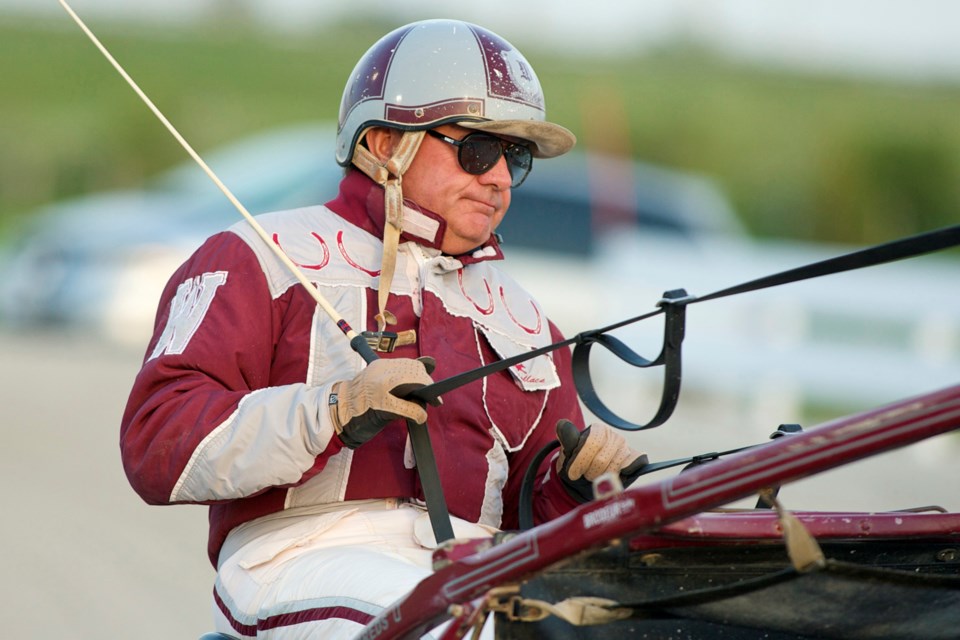 Standardbred horse trainer Ben Wallace of Puslinch races in the Upper Canada Cup at Georgian Downs in 2009. Wallace is in his 50th year in the sport.