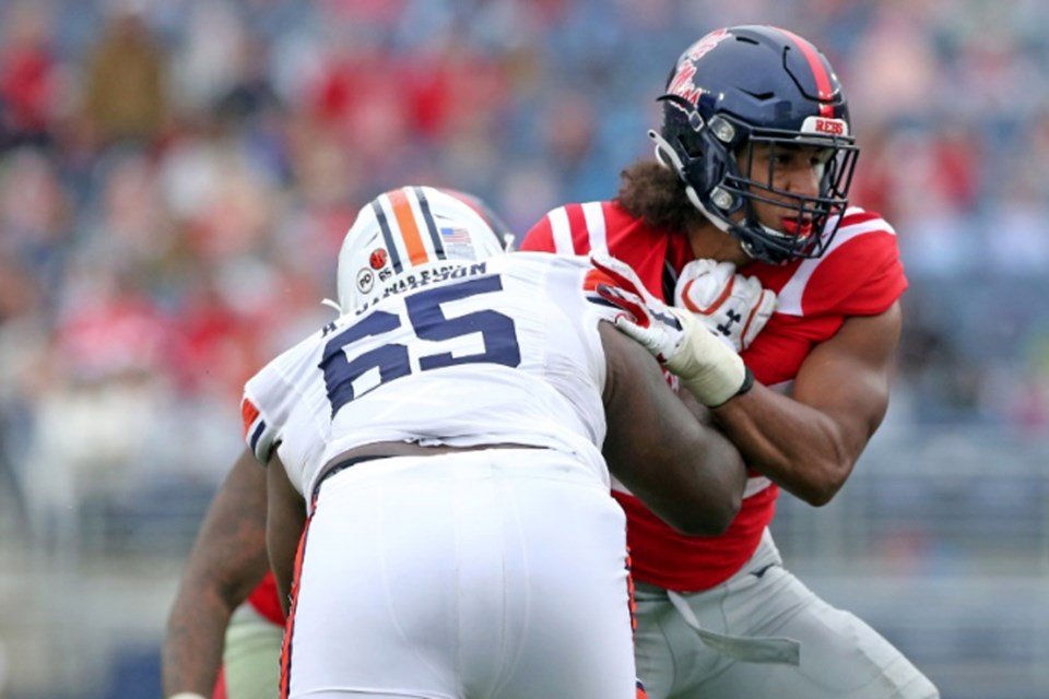 Guelph's Tavius Robinson (right) of the Ole Miss Rebels shoves offensive lineman Alec Jackson of the Auburn Tigers out of the way during NCAA football play last October. Robinson was in his first season with Ole Miss after two seasons of Ontario university football play with the Guelph Gryphons. Petre Thomas/Ole Miss Athletics