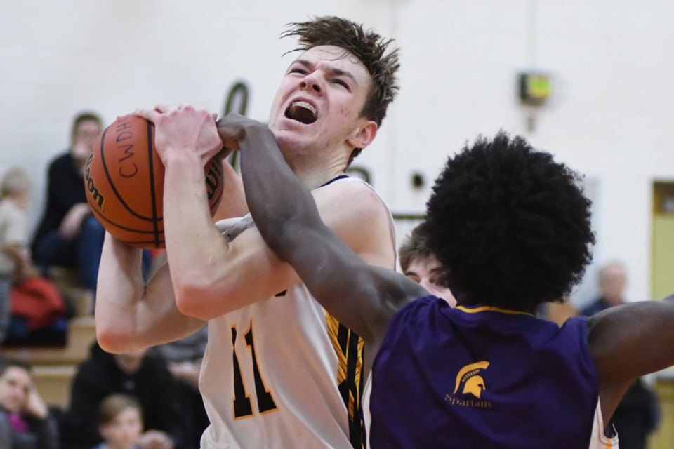 Brock Newton, left, of the Centre Wellington Falcons grimaces as he fights to go up for a layup during a District 10 high school senior boys' basketball match against the Centennial Spartans during the 2018-19 season. Newton has joined the Bucknell Bison for NCAA D1 basketball.