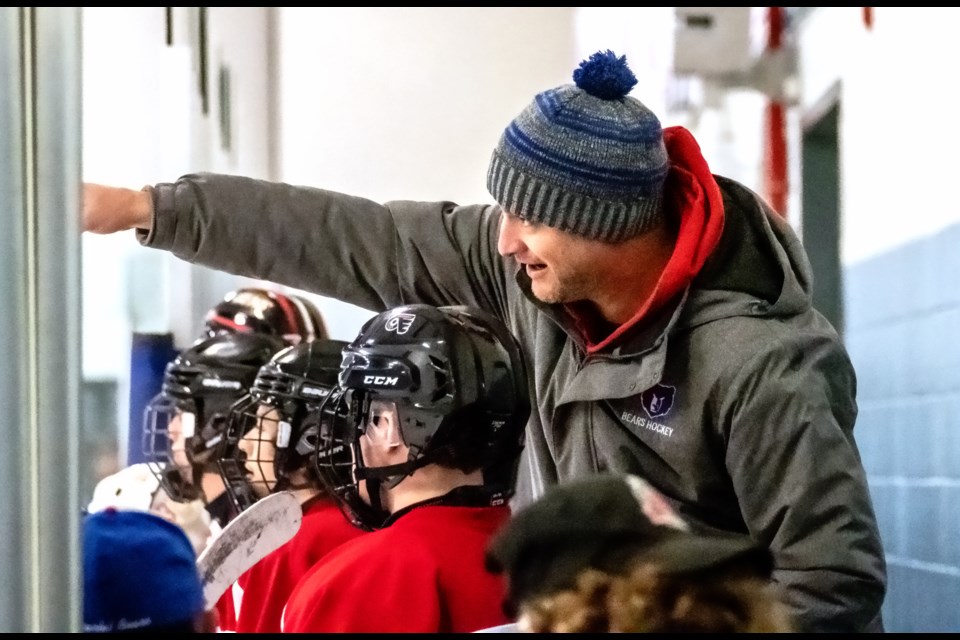Orangeville DHS Bears head coach Justin Davis gives  pointers to one of his players at last week's CWOSSA AAA high school boys' hockey championship.