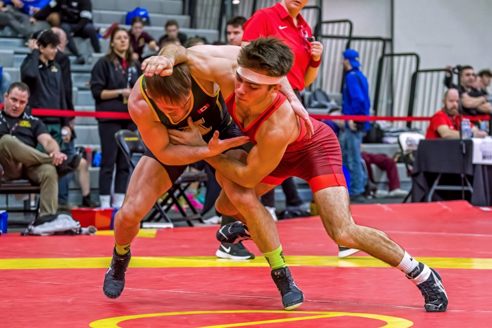Tristan Cako, right, of the Guelph Gryphons grapples with Talon Hird of Alberta during the U Sports wrestling championships at the University of Guelph. Cako finished as the silver medalist in the men's 57 kg. class.