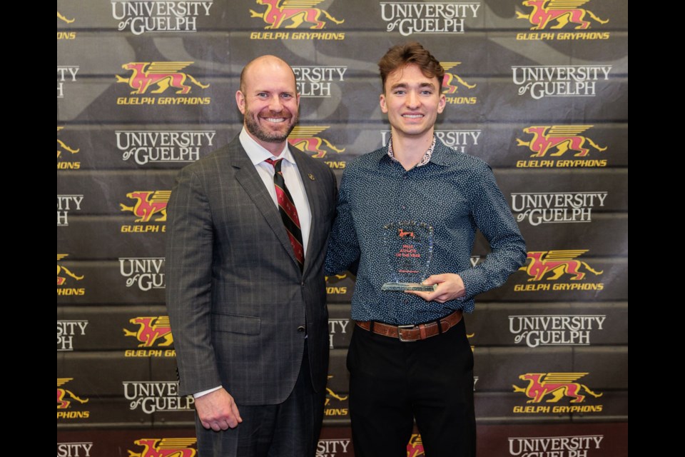 Max Davies, right, of the Guelph Gryphons men's track and field team and University of Guelph Athletics Department director Scott McRoberts pose after Davies was named the university's male athlete of the year for the 2023-24 season. The award was presented at the annual Guelph Gryphons Awards Ceremony. Kyle Rodriguez/Gryphon Athletics