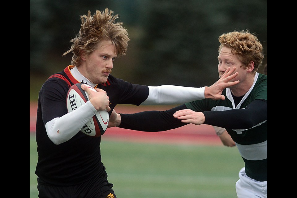Jordan Hofstra of the Guelph Gryphons fends of a University of Prince Edward Island player at the opening day of the Canadian University Rugby Championships Thursday, Nov. 16, 2017. Tony Saxon/GuelphToday