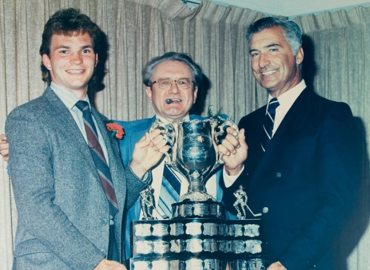 Paul Brydges, left, Guelph Platers owner Joe Holody and Guelph hockey legend Andy Bathgate pose with the Memorial Cup in 1986. Joe Holody passed away Wednesday at age 96.