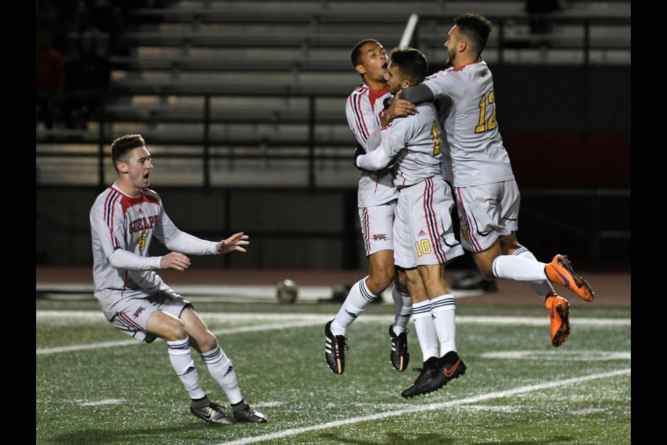 Guelph Gryphons players celebrate a goal scored during regulation time during their quarter-finals match with the Acadian Axemen at the U Sports men's soccer championship tournament Thursday at Alumni Stadium. The Gryphs won 3-2 in penalty kicks. Rob Massey for GuelphToday.