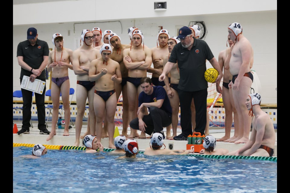Kevin Auger (holding yellow ball) is head coach of the Wildkit Swimming Organization, including this water polo team.