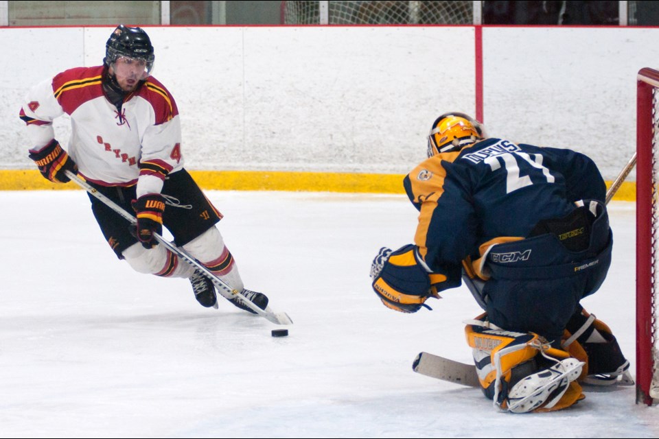 Reilly O'Connor (4) of the Guelph Gryphons skates in on goaltender Taylor Dupuis of the Ryerson Rams during Sunday's West Conference semifinal playoff series game at the Gryphon Centre. The Gryphs scored on the play on their way to an 11-3 victory. Rob Massey for GuelphToday
