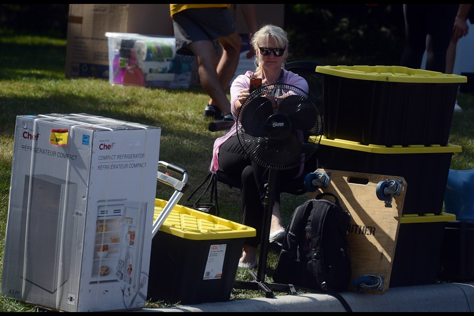 Mom waits patiently for some of the hundreds of volunteers to come help move her child's belongings into the south residence. Tony Saxon/GuelphToday