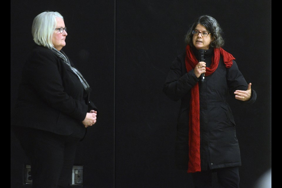 Ward 5 councillor Cathy Downer, left, listens to the Homecoming experience  of a south end resident at a town hall meeting Thursday, Nov. 23, 2017, at St. Michael Catholic School. Tony Saxon/GuelphToday