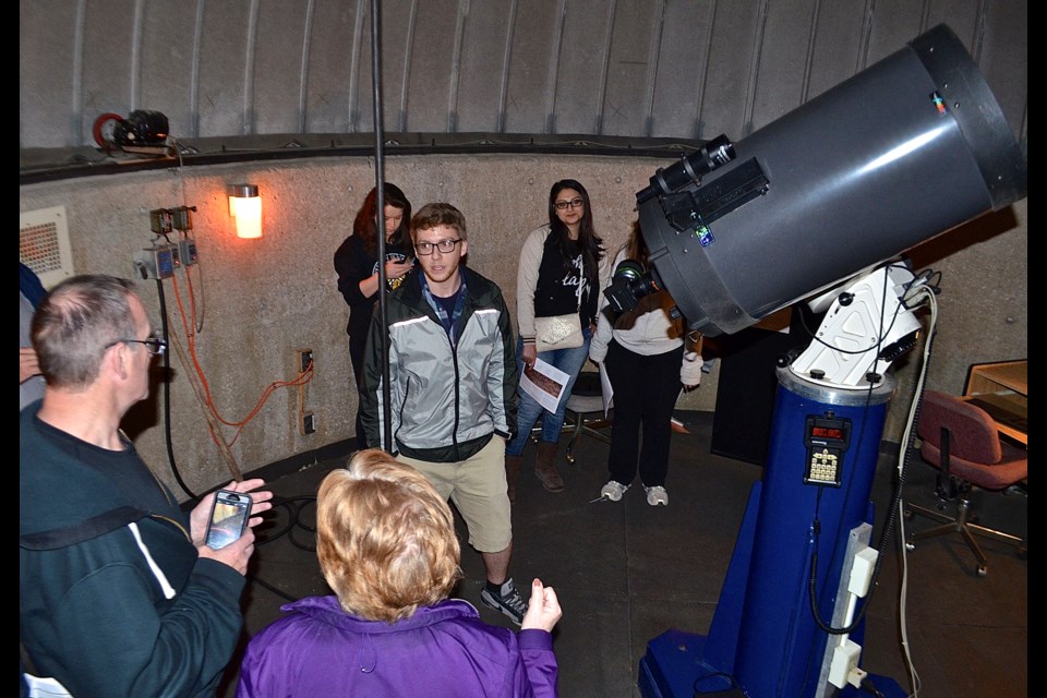 University of Guelph PhD student Andrew Harris gives visitors a tour of the U of G observatory during a presentation for families about the U of G's involvement in the Mars Curiosity mission. Troy Bridgeman for GuelphToday