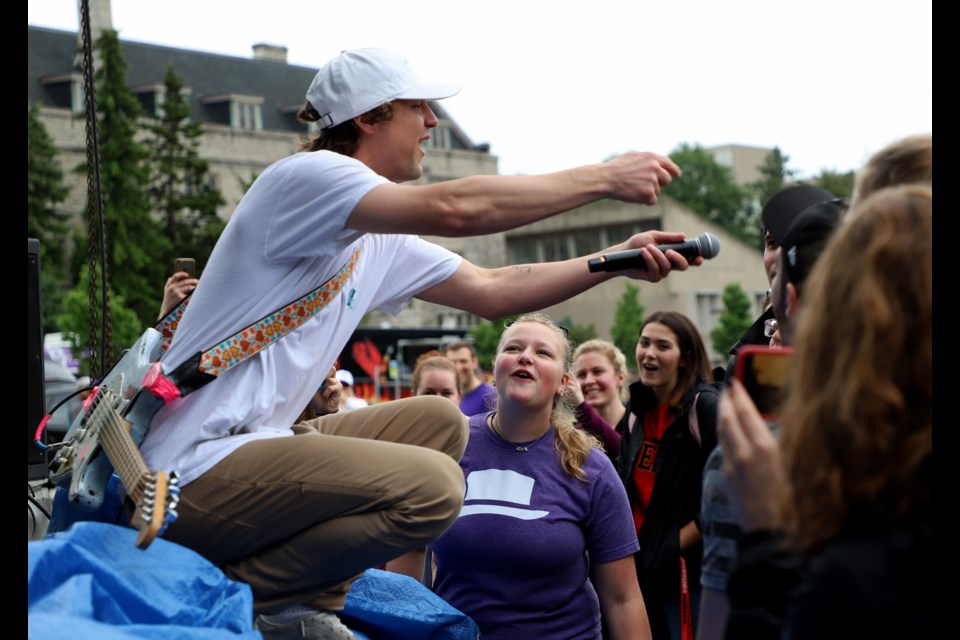 Hollerado's lead singer, Menno Versteeg, jumps down from the stage to encourage audience members to sing. Karen Tran for GuelphToday