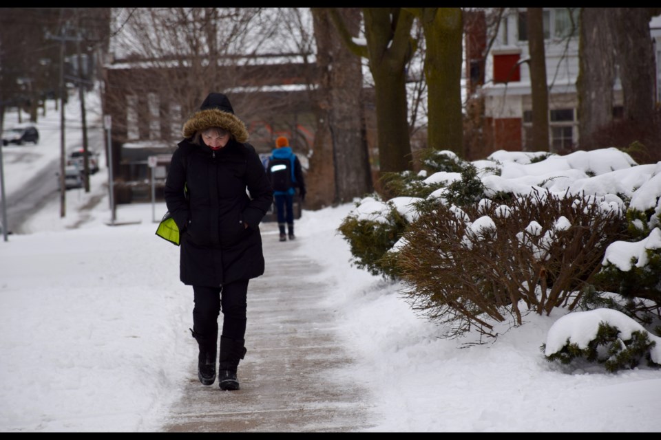 A woman walks cautiously up Suffolk Street Monday morning. Sidewalks everywhere in the city were very icy. 