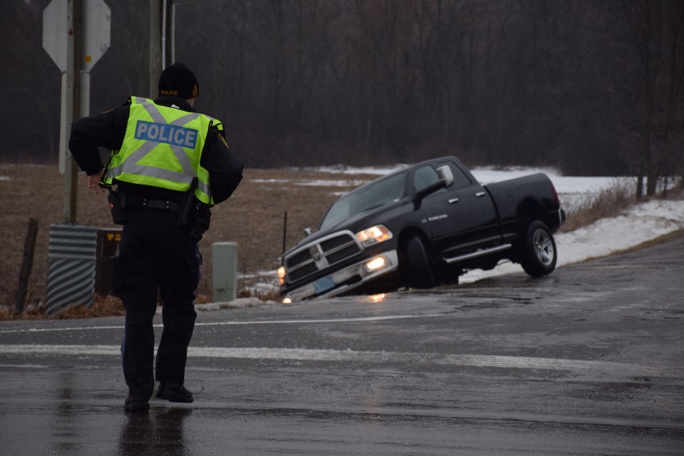 An OPP officer approaches the scene of a ditching. Rob O'Flanagan/GuelphToday