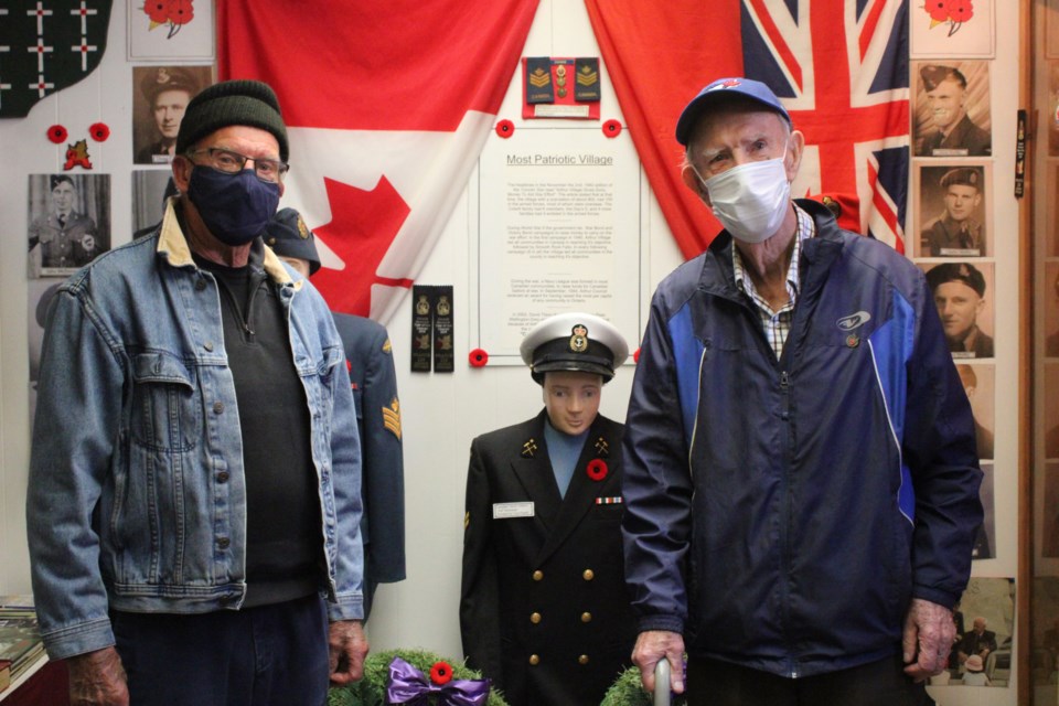Jack Benham, left, and John Walsh stand among some of the collected memorabilia in Arthur's war museum. Keegan Kozolanka/GuelphToday