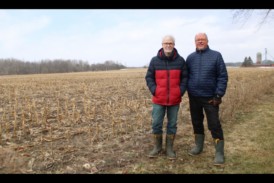 Fred Gordon, left, and Paul Jarsky stand at the edge of their property where the Ainley subdivision will be going up.