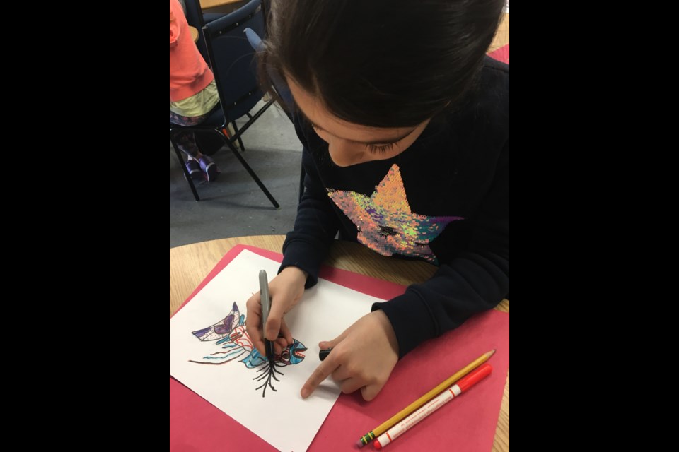 A girl uses a sharpie to illustrate her art in an Artshine class. Supplied Photo.