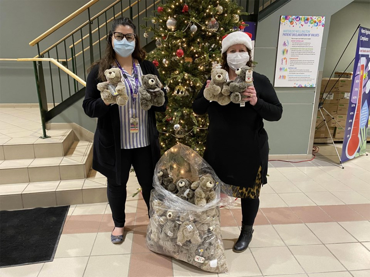 Two people delivering teddy bears
