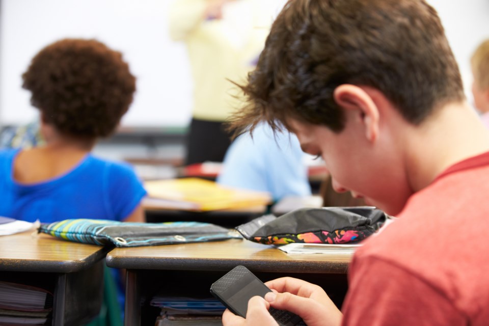 031319-cellphone in classroom-student-smart phone-AdobeStock_52158140