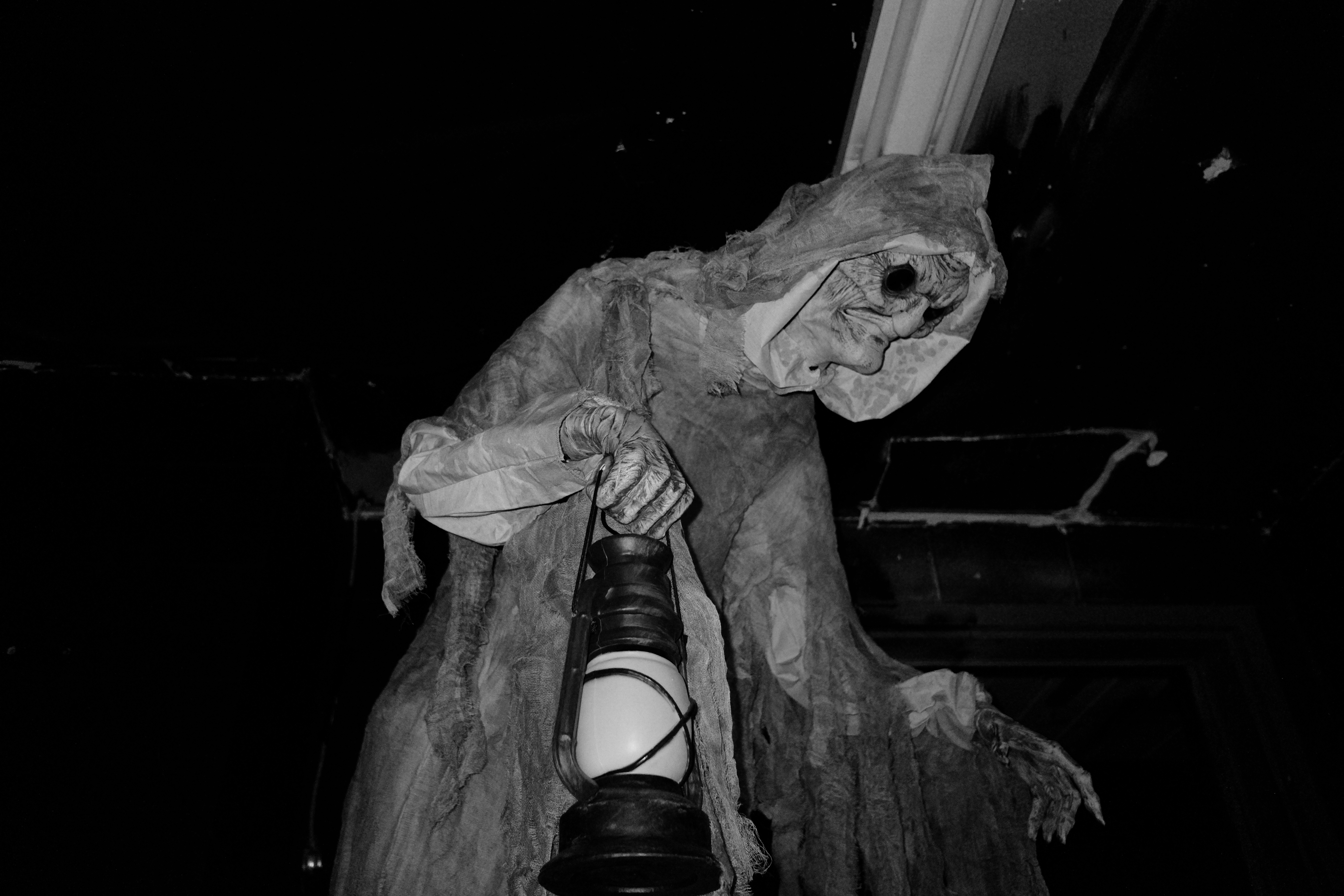 A black and white photo of an animatronic goblin. 