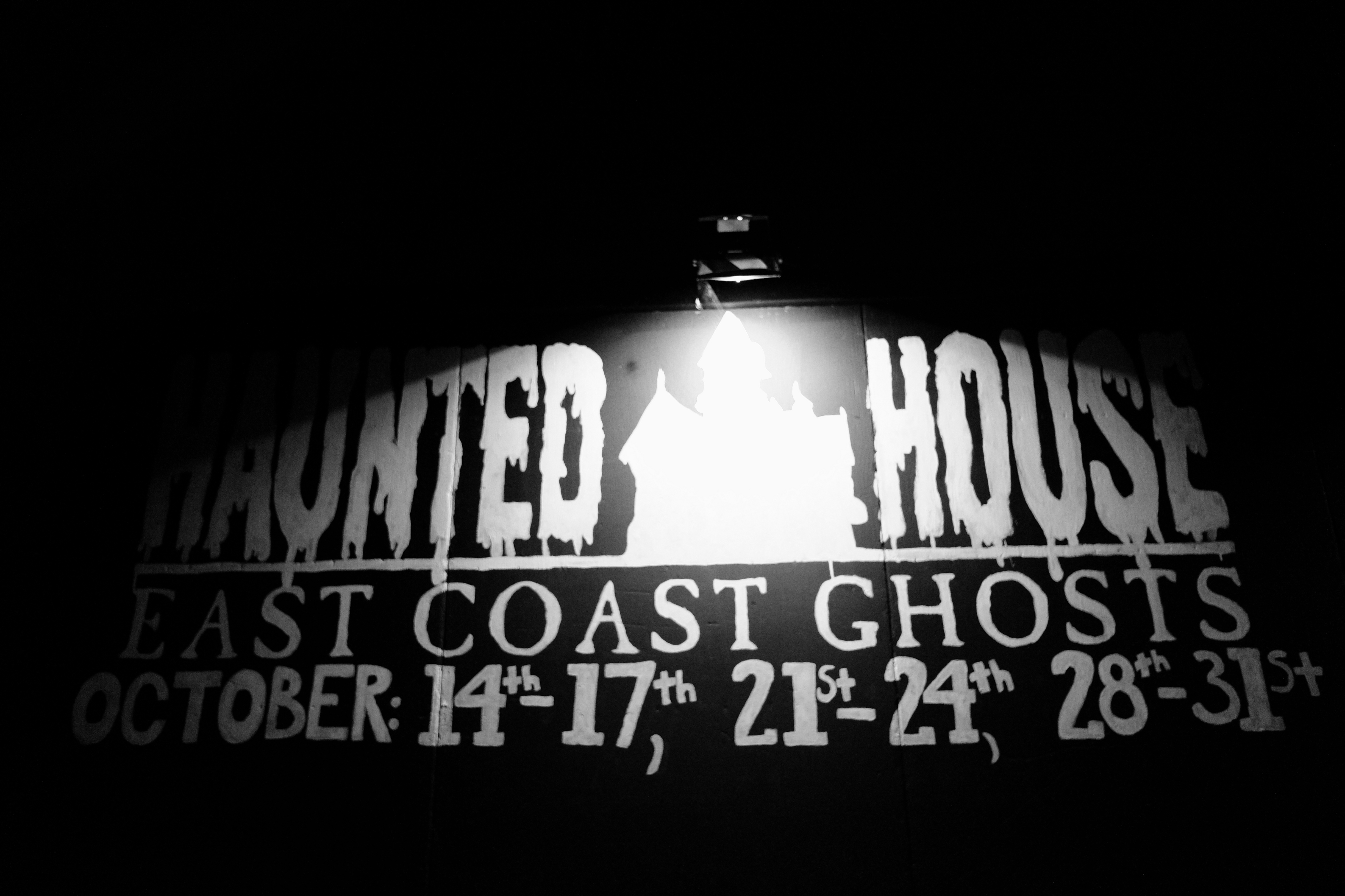 A sign listing the opening times of the Bluenose Ghosts Festival Haunted House