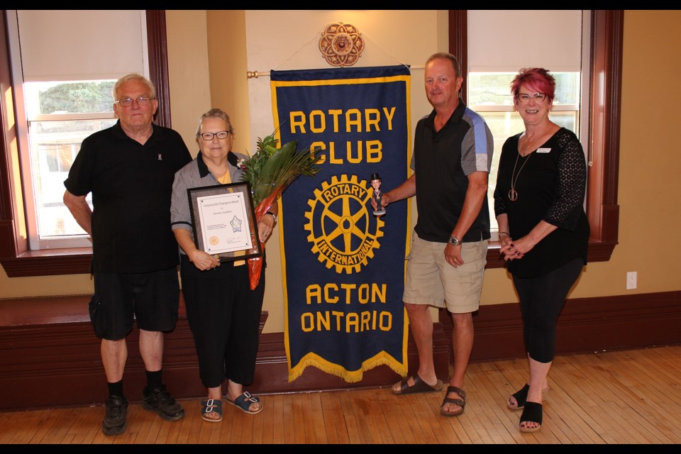 Beverley McKnight Baddeley is recognized as a Community Champion by the Rotary Club of Acton's (from left) Colin Ash, outgoing president Bill Vanderyt and Nancy Wilkes.