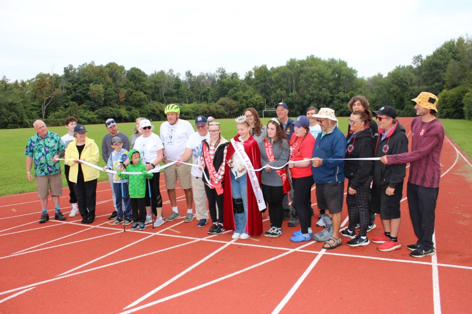 Miss Acton Fall Fair Mackenzie Hamilton - joined by first runner up Ivy Bell and second runner up Daelin Andrews - cuts the ribbon to start the Acton Terry Fox Run.