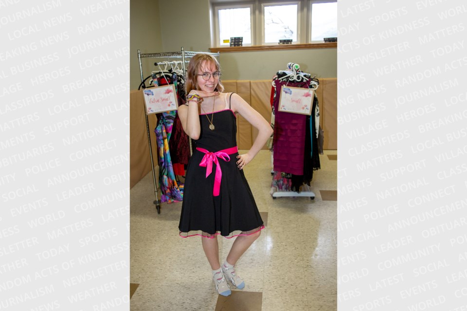 Amaryn van Donkersgoed tries on one of the hundreds of free dresses available at Bethel's Say Yes to the Dress event on Friday evening.