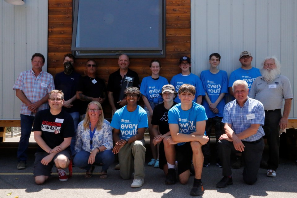 Group photo of the team and stakeholders. (Back row, left to right) Wade Richardson of OYAP, David Heart, Doug Doolittle, Ronald Rusk, Kai Mars, Nate Carruthers, Bradley Kerr, Anthony Hancock, Councillor Jon Hurst. (Front row, left to right) Principal Mike Gallant, Donna Orrie (HDSB), Isaiah Mathews, Josh Santos, Brodie Hennessey, Hugh Hyndman of Habitat for Humanity. 