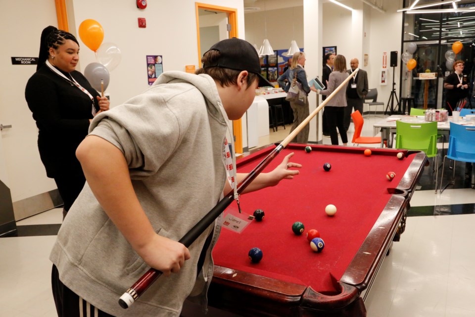 Cyrah Priebe (left) of ADAPT plays pool with a member of the Youth Centre.