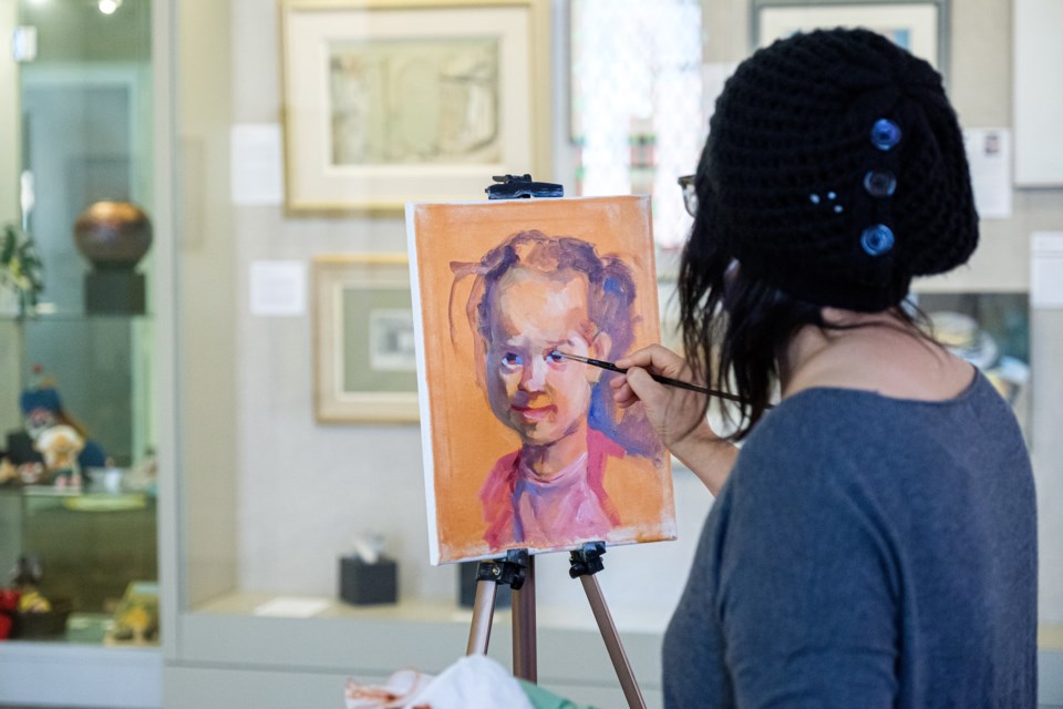 A Culture Days participant paints a portrait.