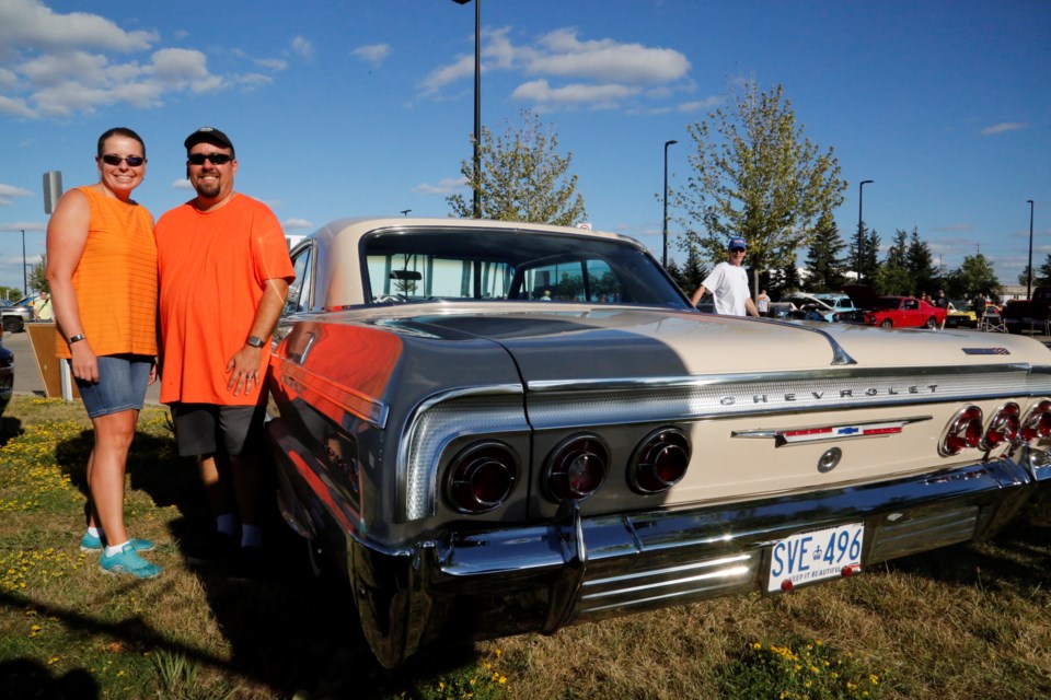 Allison and Mike Farrugia pose with his grandfather's 1964 Chevy Impala.