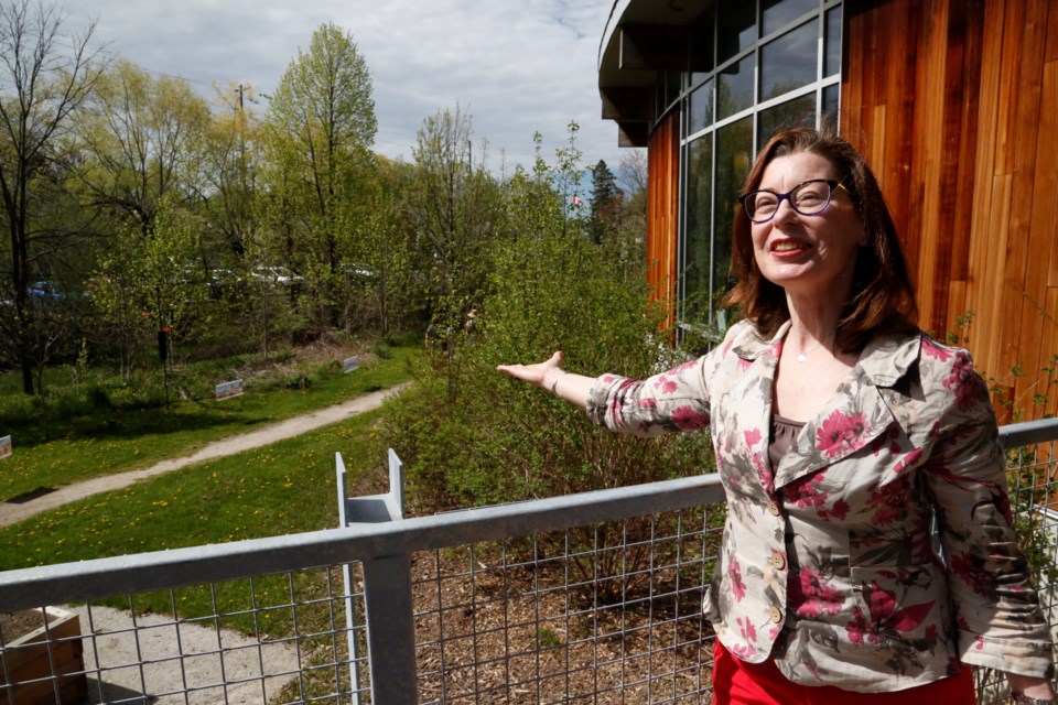 Halton Hills Public Library CEO Melanie Southern points to some of the bird feeders that can be seen from the reading deck.