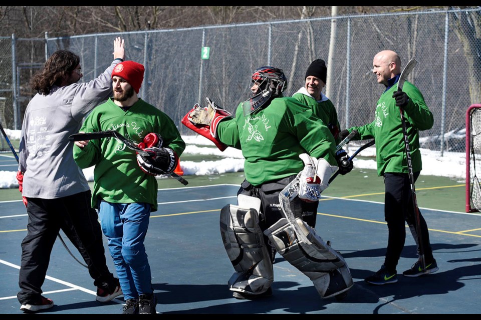 TD 'Other' Wealth and Uptown Audi Turbo players exchange high fives at the charity ball hockey tournament held at the Georgetown Racquet Club Saturday afternoon. The event raised funds for the Georgetown Hospital Foundation and Addison's Wish Fund, paying tribute to a young Georgetown girl who passed away following a short battle with cancer.