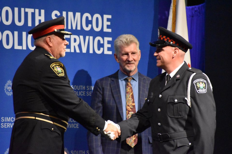 South Simcoe Police Service auxiliary officer Ryan Gainer, right, received the Auxiliary Outstanding Leadership Award. Also pictured are Chief John Van Dyke, left, and police board chair Chris Gariepy.