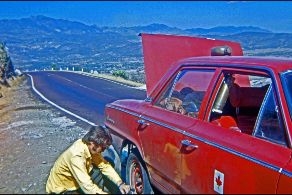 Eric Whitehead and Murray Jupe took a five-month road trip together in the 1970s. Here they are stopped at the side of the road, fixing a flat tire in Mexico. Submitted.