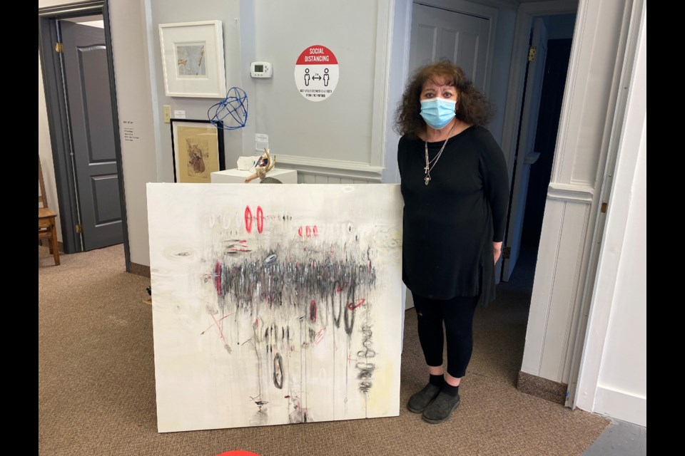 Director of the be contemporary gallery Jeanette Luchese with one of her pieces 'Memoria 2020' created during the pandemic, her version of the COVID "Curve". 