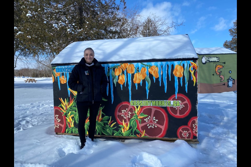 Artist Cassidy Morriss stands beside her piece of art on Friday morning at Innisfil Beach Park