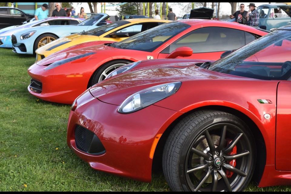 Row of high-end sports cars at the Innisfil Beach Cruisers Car Club's car show at Innisfil Beach Park.