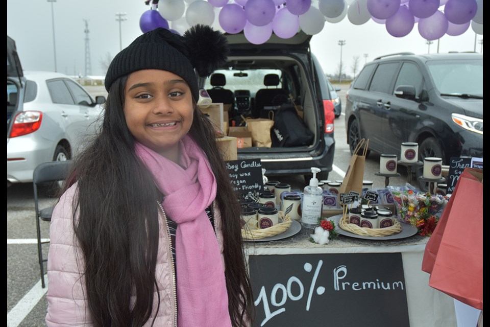 Cienna, the founder of Cienna Yen hand-poured soy candles, at the Pop-up Market in Innisfil.