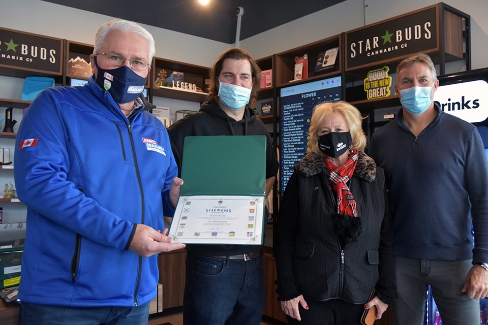 From left, MP John Brassard presents certificate of congratulations to Star Buds store manager Eric Dawes as Coun. Donna Orsatti and store owner Stew Garner look on.