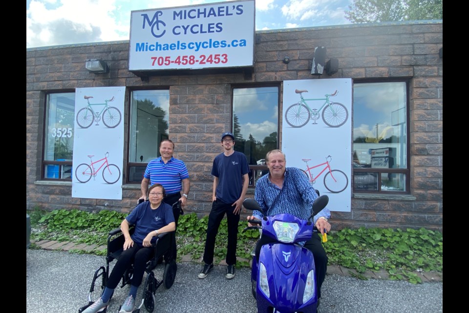 Michael Menzies with wife Iris, along with shop employee Aric Howser and friend Scott Hill. 