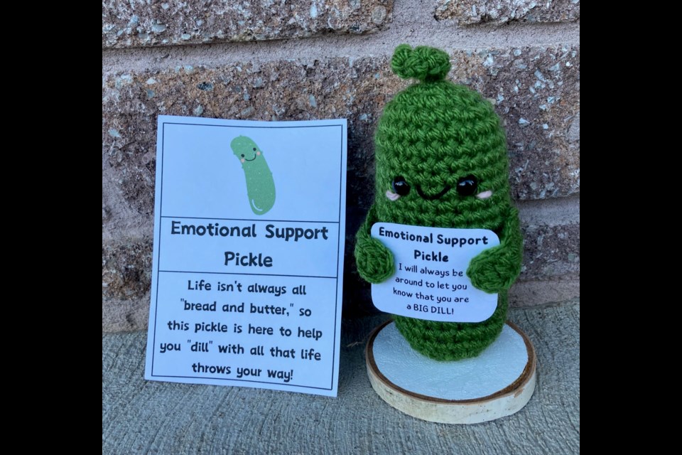 Bouquet Beanies offers completed creations — including twisted crocheted headbands/ear warmers, coffee cozy sleeves, and emotional support pickles (pictured) —  and numerous crocheting patterns.