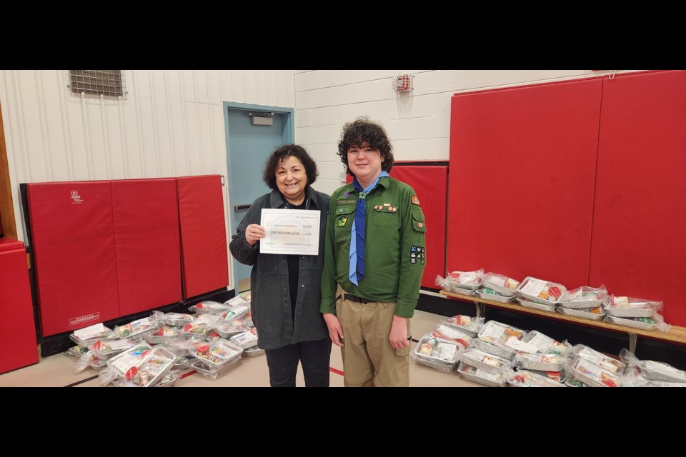 The president of Christmas for Kids, Myrlene Boken, with Nathan Brennan.