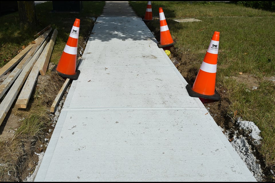 New section of sidewalk on AnnaMaria Avenue in Alcona, showing gaps between the cement and the ground on Aug. 31.