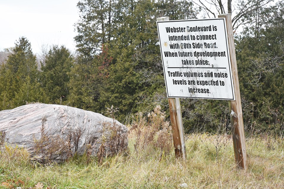 Sign posted at the northern cul-de-sac end of Webster Boulevard warns of plans to extend the roadway to Sideroad 20.