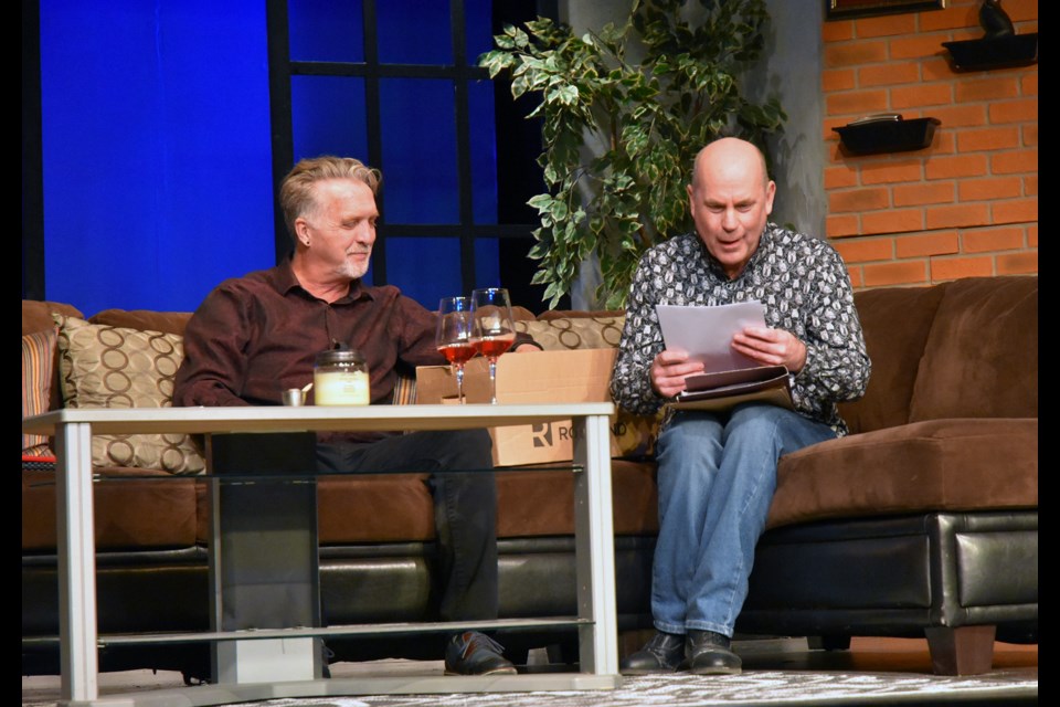 At left Paul, played by Frank Kewin, shows David (Robert Knapp) some of the manuscripts left by his wife Tara  (Peg Eberhard, heard only as a voice), in Burn. 