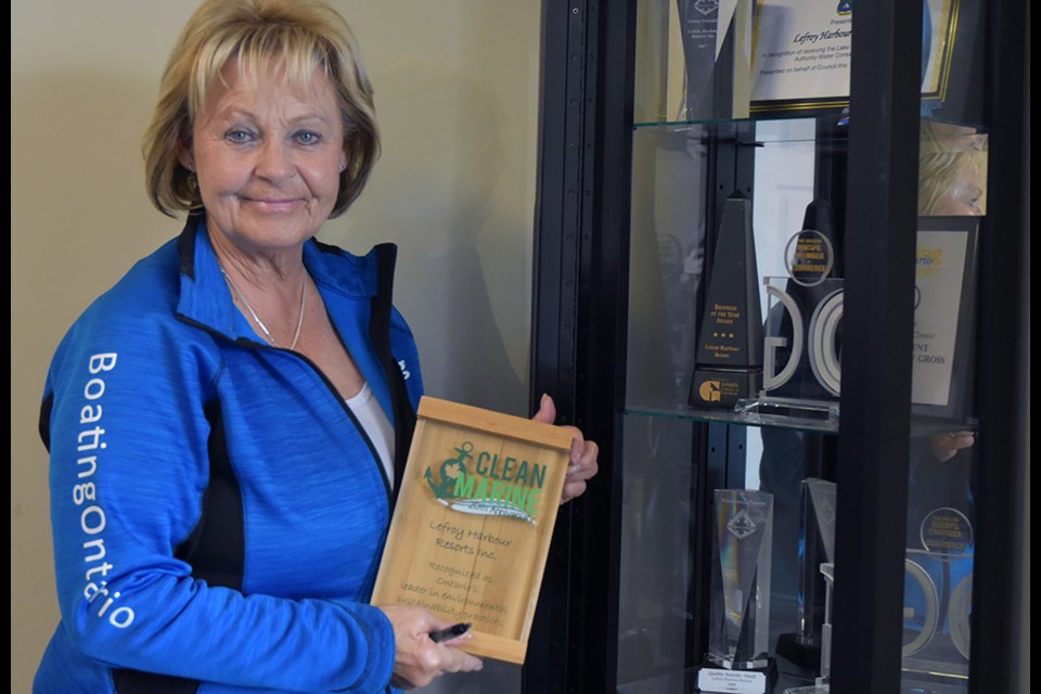 Linda Ellery, marina manager at Lefroy Harbour Resorts, with top awards presented to the company.